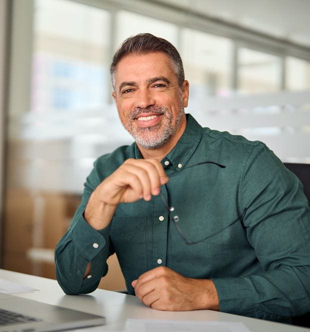 A smiling HR business partner at his desk